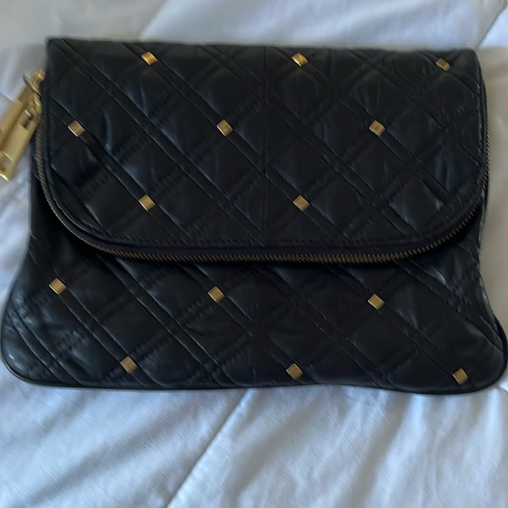 Soft leather clutch with gold accents and zippers